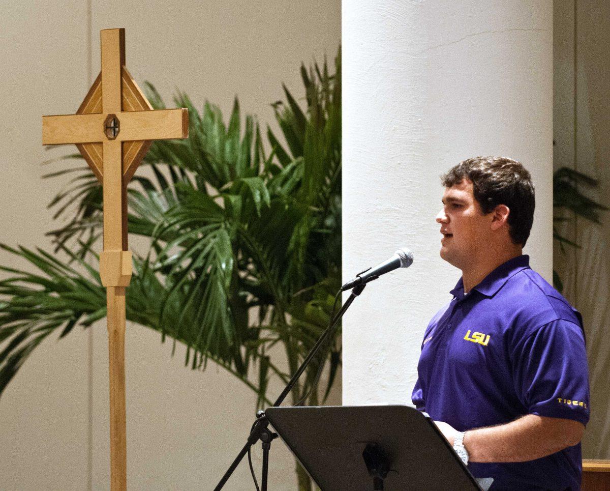 Junior center Ben Domingue speaks at Christ The King's 8 p.m. mass Sunday night.