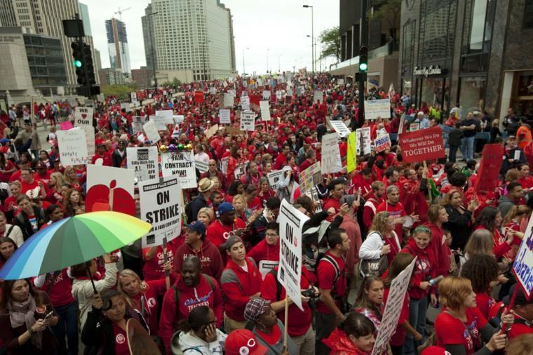 Thousands of public school teachers and their supporters rally outside the Hyatt Regency Hotel to protest against Penny Pritzker, whom they accuse of benefiting from being a board member of both the Chicago Board of Education and Hyatt Hotels on Thursday, Sept. 13, 2012 in Chicago. (AP Photo/Sitthixay Ditthavong)
 