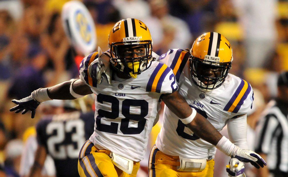 LSU cornerback Jalen Mills (28) celebrates with LSU safety Craig Loston (6) after tackling a Washington player Saturday, Sept. 8, 2012 during the Tigers' 41-3 win over the University of Washington Huskies in Tiger Stadium.