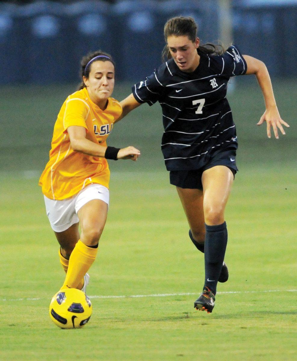 LSU freshman forward Fernanda Pi&#241;a (7) fights off Rice freshman forward Lauren Hughes (7) to keep possession in Friday&#8217;s game against Rice at the Soccer Complex.