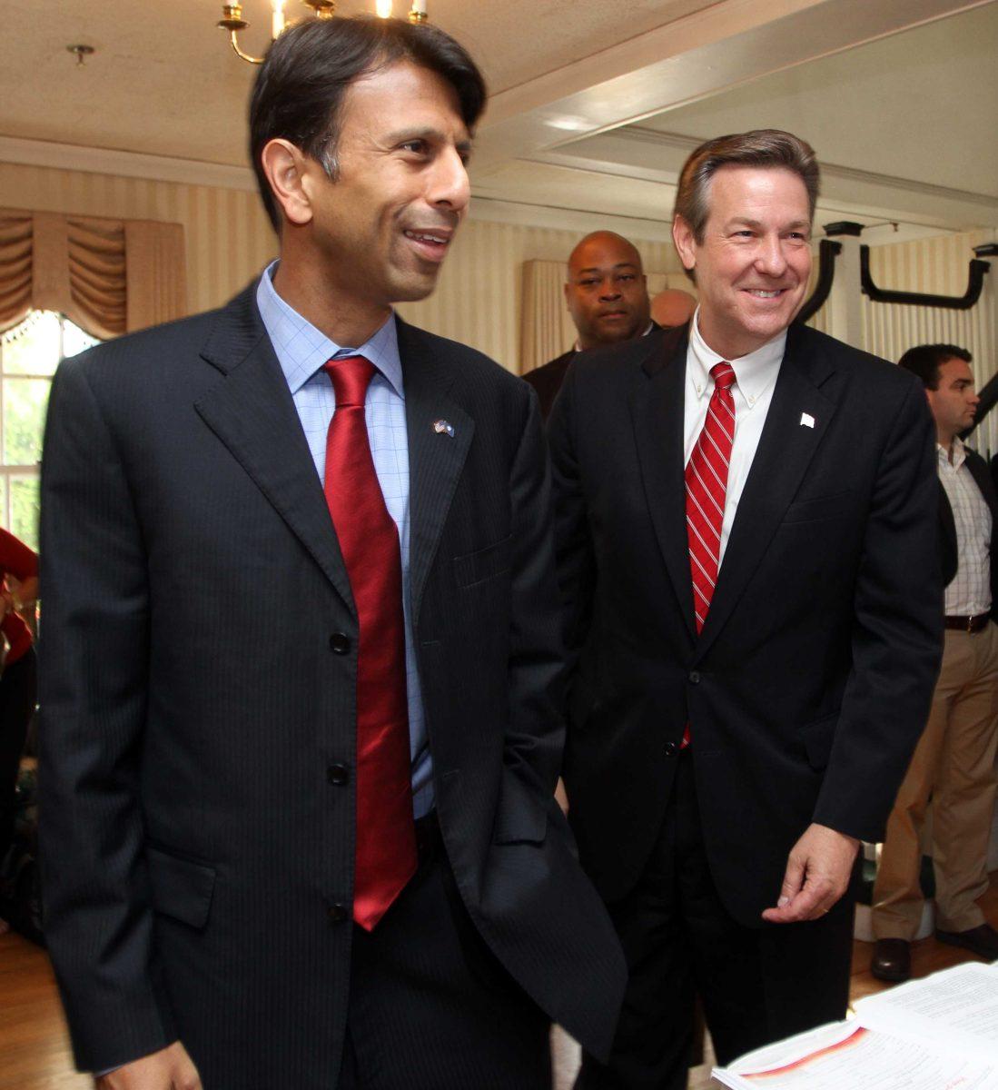 Gov. Bobby Jindal, R-La., left, arrives with Republican nominee for governor Ovide Lamontagne for a Republican Unity Breakfast following Tuesday's state primary Thursday, Sept. 13, 2012 in Bedford, N.Hl (AP Photo/Jim Cole)