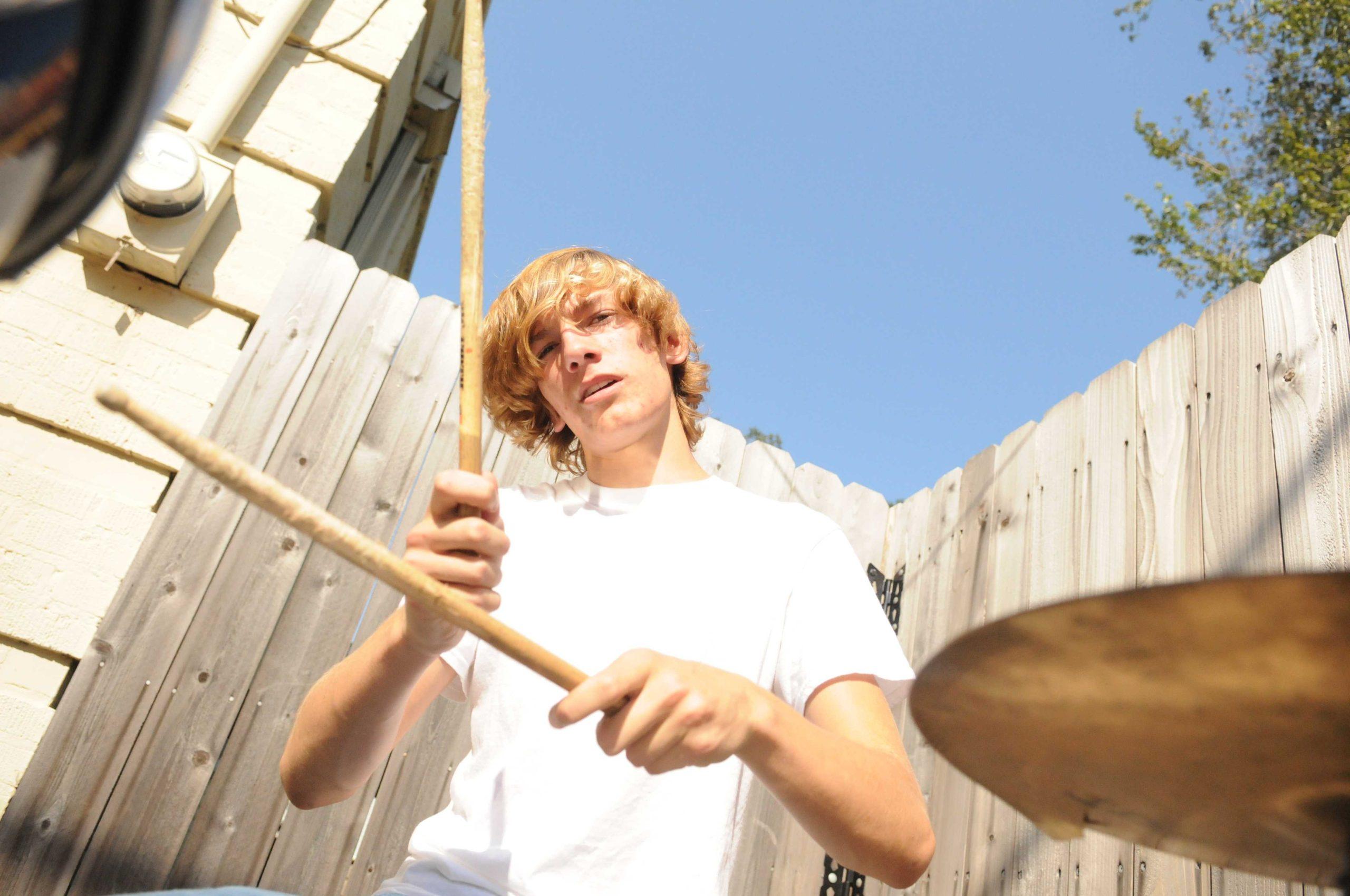 Shirtless high school band serenades drivers on Highland