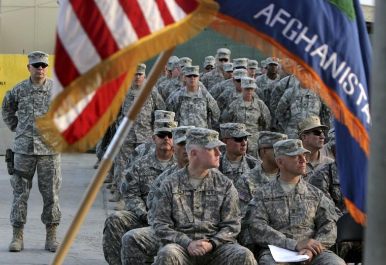 FILE - In this Sept 11, 2008 file photograph, US soldiers attend a ceremony marking the 7th anniversary of the Sept. 11 attacks, at the U.S Camp Phoenix in Kabul, Afghanistan. .U.S. military deaths in Afghanistan have surpassed 2,000, a grim reminder that a war which began nearly 11 years ago shows no signs of slowing down despite an American decision to begin the withdrawal of most of its combat forces. (AP Photo/Musadeq Sadeq, File)
 