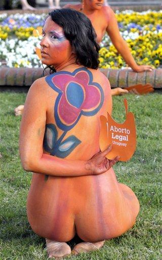 A pro abortion activist, with her body painted, demonstrates in front of the Uruguayan congress in Montevideo, Uruguay, Tuesday, Sept. 25, 2012. Uruguay's congress appeared ready on Tuesday to legalize abortion, a groundbreaking move in Latin America, where no country save Cuba has made abortions accessible to all women during the first trimester of pregnancy. The sign reads in Spanish "legal abortion." (AP Photo/Matilde Campodonico)
 