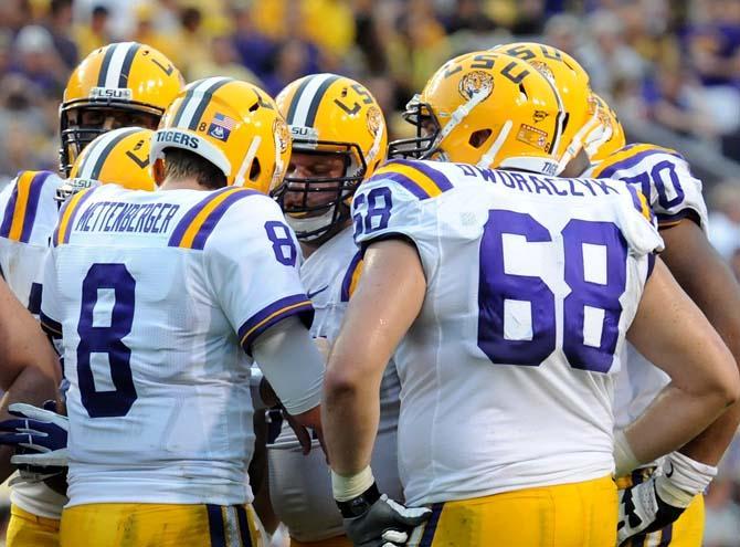 Sixth-year senior Josh Dworaczyk (68) joins the huddle with junior quarterback Zach Mettenberger (8) Saturday, Sept. 8, 2012. Dworaczyk was out for the 2011 season but gained an additional year of eligibility to play this season.
 