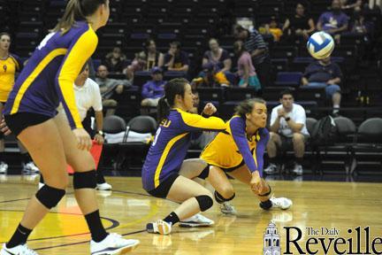 A member of the Purple team goes for a dig Saturday in a game against the Gold team.
 