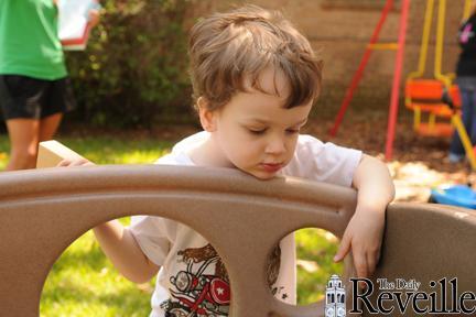 Mason, two years old, plays outside during his first day as an LSU Language Preschool student at the Dean French House on Infirmary Road.
 