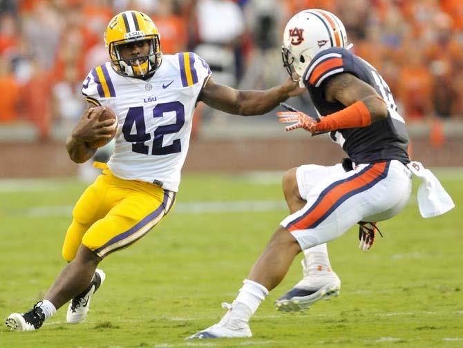 LSU junior running back Michael Ford (42) dodges a tackle from Auburn junior defensive back Demetruce McNeal (12) during the Tigers' 12-10 victory over Auburn on Saturday Sept. 22, 2012 in Jordan-Hare Stadium.
 