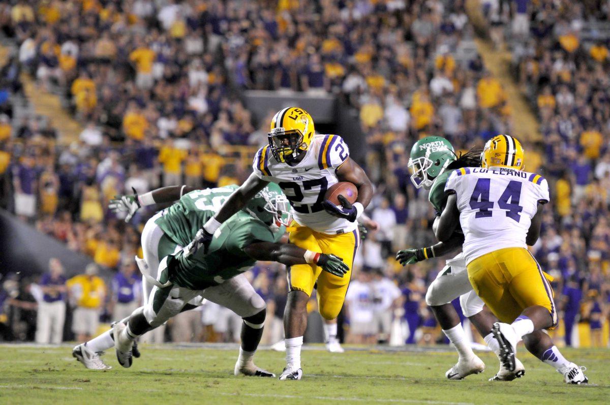 LSU sophomore running back Kenny Hilliard (27) breaks through a tackle in the Tigers' 41-14 victory over North Texas Saturday in Tiger Stadium.