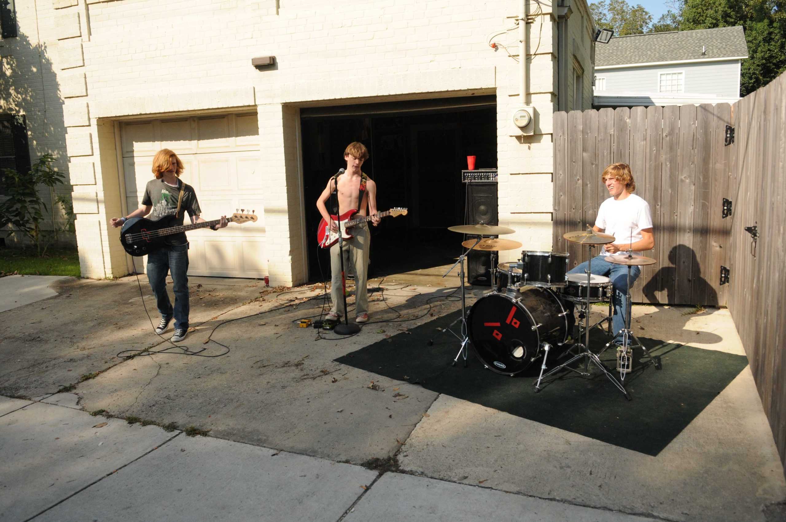 Shirtless high school band serenades drivers on Highland