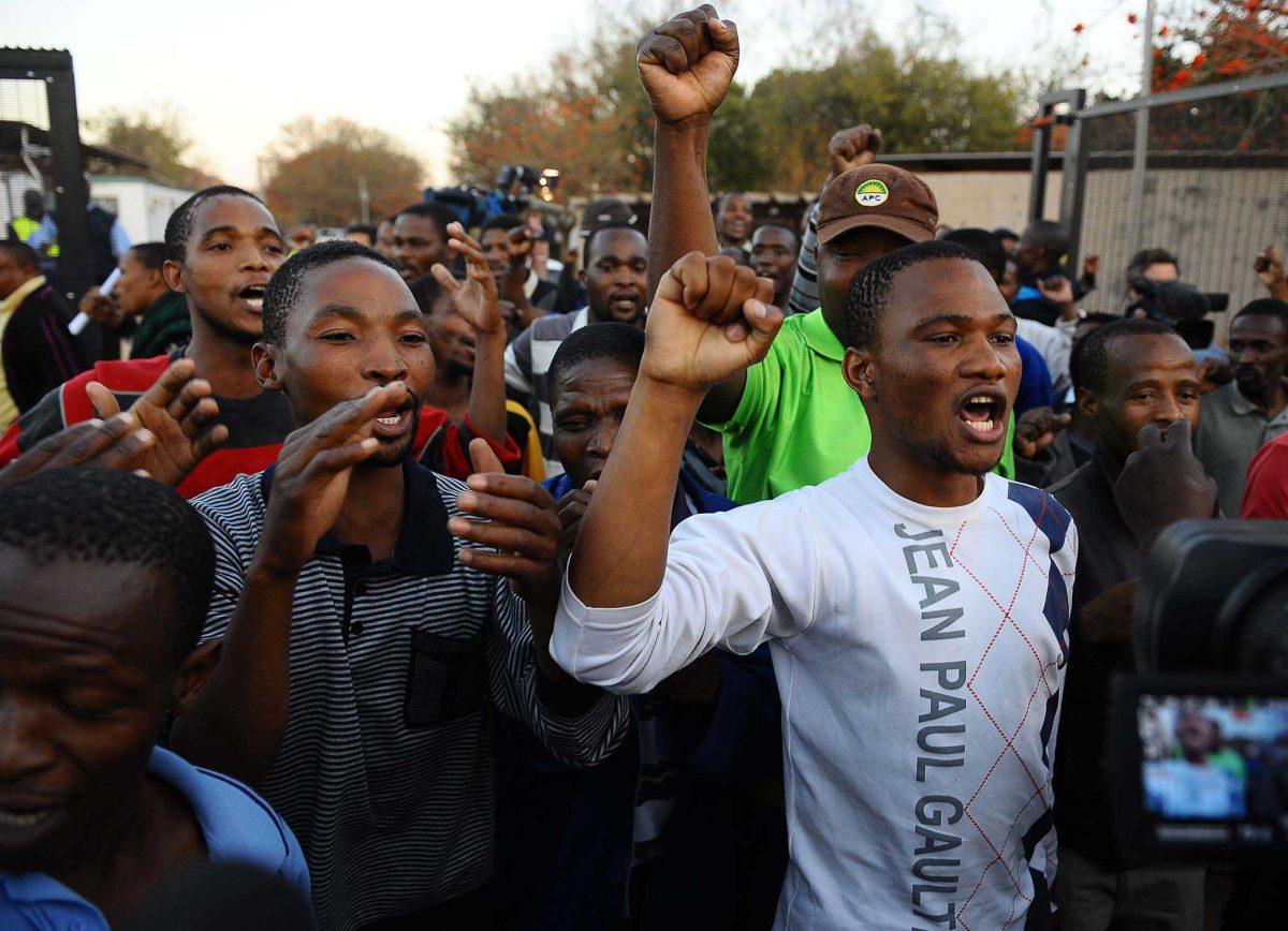 Released mine workers celebrate their release at Ga-Rankuwa Magistrate's Court, Pretoria, South Africa, Monday, Sept. 3, 2012. The miners were among those arrested for public violence after the police opened fire on a group of striking mineworkers killing 34 and wounding 78 at Lonmin's Marikana platinum mine on August 16. Last week, prosecutors said the men arrested would be charged with the murder and attempted murder of their colleagues. Following a public outcry the charges were provisionally withdrawn on Sunday. (AP Photo)