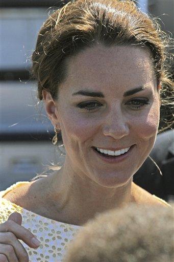 Britain's Kate, the Duchess of Cambridge, smiles as she and Prince William prepare to depart Honiara, Solomon Islands, Tuesday, Sept. 18, 2012, after an official visit to the South Pacific Island nation. (AP Photo/Rick Rycroft)
 