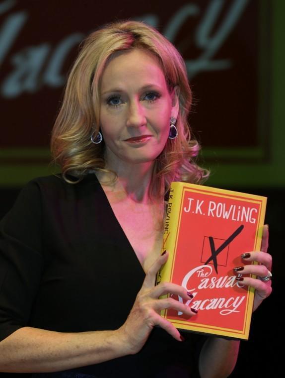 British writer J.K. Rowling poses for the photographers with her new book, entitled: 'The Casual Vacancy', at the Southbank Centre in London, Thursday, Sept. 27, 2012. The book, published by Little, Brown Book Group, is Rowling's first novel for adults after writing the Harry Potter series. (AP Photo/Lefteris Pitarakis)
 