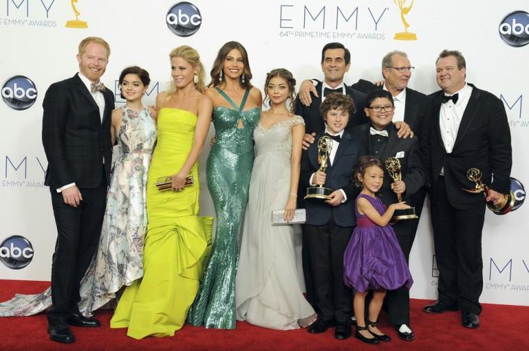 The cast of "Modern Family", from left, Jesse Tyler Ferguson, Ariel Winter, Julie Bowen, Sof&#237;a Vergara, Sarah Hyland , Ty Burrell, background, Nolan Gould, Ed O'Neill, background second left, Rico Rodriguez, Aubrey Anderson-Emmons, foreground purple dress, and Eric Stonestreet, right, winners of the best outstanding comedy series, pose backstage at the 64th Primetime Emmy Awards at the Nokia Theatre on Sunday, Sept. 23, 2012, in Los Angeles. (Photo by Jordan Strauss/Invision/AP)
 