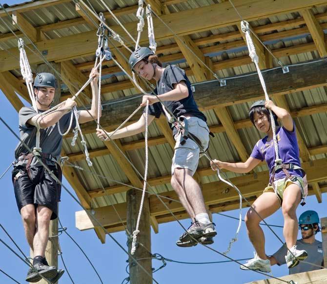 hemistry graduate student Tian Tian and physics freshman Jay Cranford participate in the UREC&#8217;s challenge course Sunday.