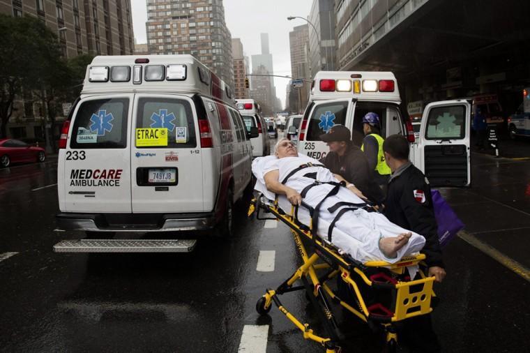 A patient is wheeled to an ambulance in the rain during an evacuation of New York University Tisch Medical, Tuesday, Oct. 30, 2012, in New York. Sandy, the storm which was downgraded from a hurricane just before making landfall, caused multiple fatalities, halted mass transit and cut power to more than 6 million homes and businesses (AP Photo/ John Minchillo)
 