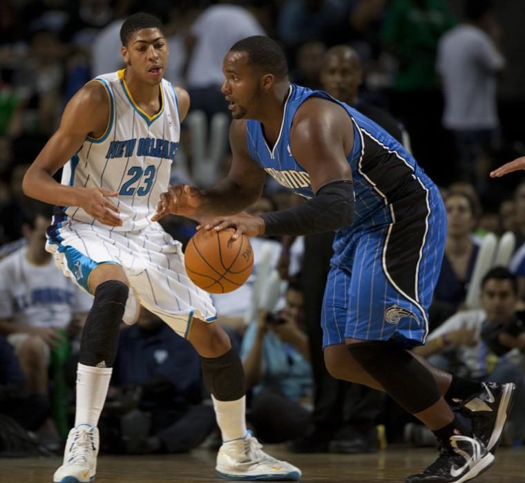 Orlando Magic Glen Davis, right, drives to the basket against New Orleans Anthony Davis (23) during a NBA preseason basketball game in Mexico City, Sunday, Oct. 7, 2012. (AP Photo/Christian Palma)
 