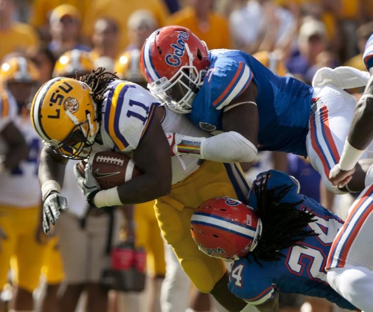 LSU then-sophomore running back Spencer Ware (11) gets taken down by Florida defenders Saturday, Oct. 8, 2011 during last season's 41-11 over the Gators in Tiger Stadium. The No. 4-ranked Tigers travel to Gainesville this weekend to take on No. 11 Florida.
 