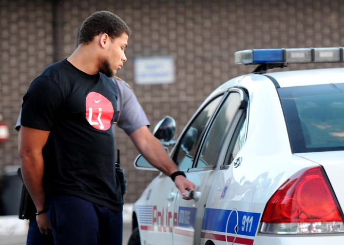 Former LSU star cornerback Tyrann Mathieu is placed in a police car Thursday, Oct. 25, 2012 at Baton Rouge Police Department Second District Police Station after he and former LSU football players Jordan Jefferson, Derrick Bryant and Karnell Hatcher were found at&#160;262 W. State St. with 18 grams of marijuana.
 