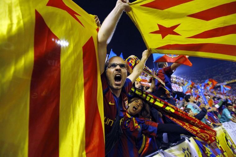 FILE- In this April 20, 2011, file photo, Barcelona fans wave pro-independence Catalonia flags during the final of the Copa del Rey soccer match between Real Madrid and FC Barcelona at the Mestalla stadium in Valencia, Spain. More than ever, FC Barcelona, known affectionately as Barca, lived up to its motto of being "more than a club" for this wealthy northeastern region where Spain's economic crisis is fueling separatist sentiment. Barca has been seen as a bastion of Catalan identity dating back to the three decades of dictatorship when Catalans could not openly speak, teach or publish in their native Catalan language. Barcelona writer Manuel Vazquez Montalban famously called the football team "Catalonia's unarmed symbolic army." (AP Photo/Andres Kudacki, File)
 