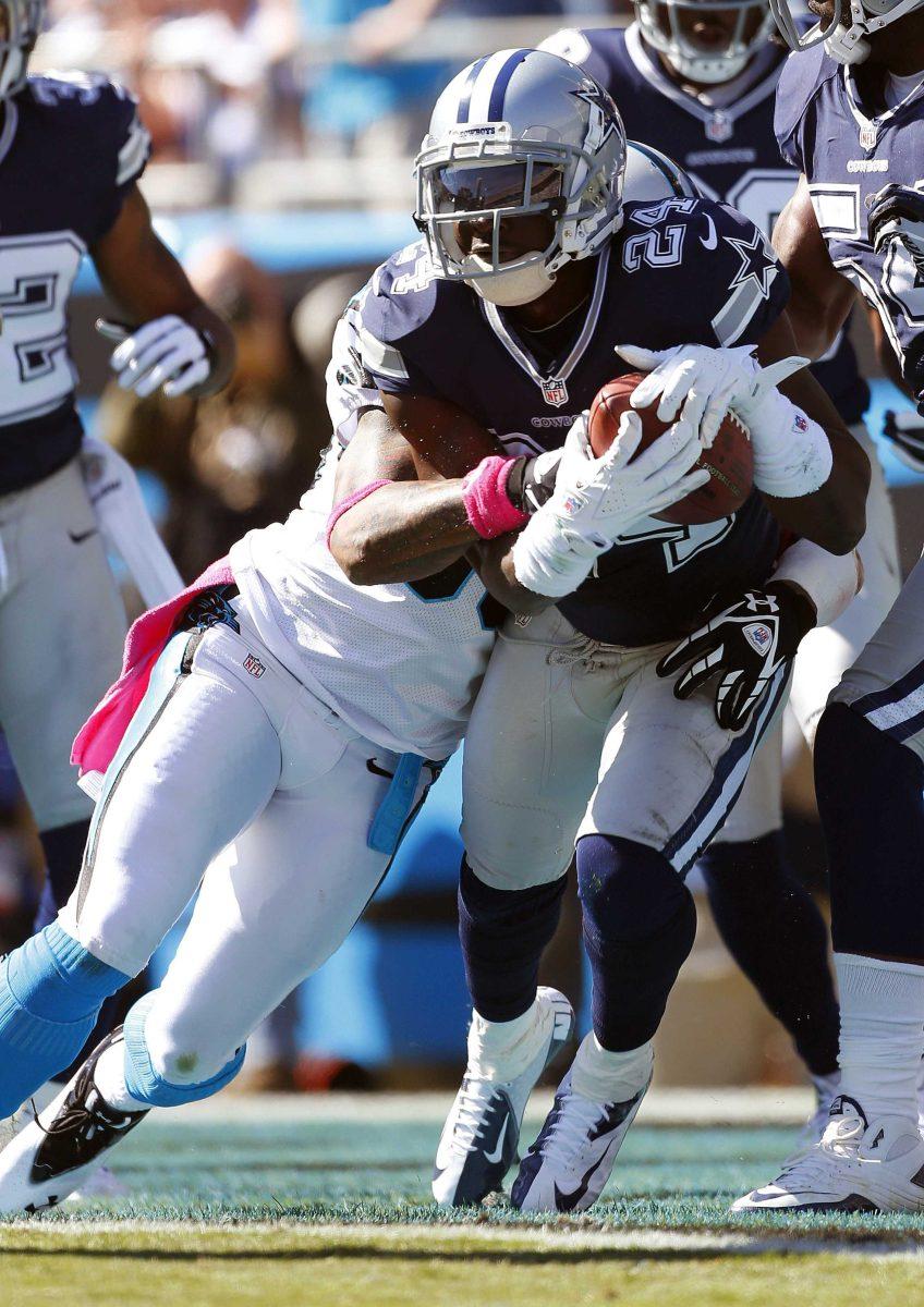 Dallas Cowboys cornerback Morris Claiborne (24) picks off a pass from Carolina Panthers quarterback Cam Newton a Panthers wide receiver Steve Smith , front left, makes the tackle during the first half of an NFL football game on Sunday, Oct. 21, 2012, in Charlotte, N.C. (AP Photo/Bob Leverone)