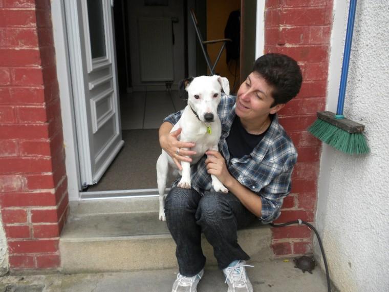 Sabrina Zamora, president of an animal protection association, Ligue Interet a la Societe et de l'Animal/L.I.S.A., holds a Jack Russell terrier, Ethan, at his new home in Charleville Mezieres, eastern France, Friday, Oct. 19, 2012. Ethan, doomed to die on his third birthday when he was poisoned and buried alive, has survived on Tuesday, Oct. 16, 2012. Ethan can thank a witness, a firefighter who came to the rescue and a veterinarian who nursed him back to life. (AP Photo/Sylvie/LISA)
 