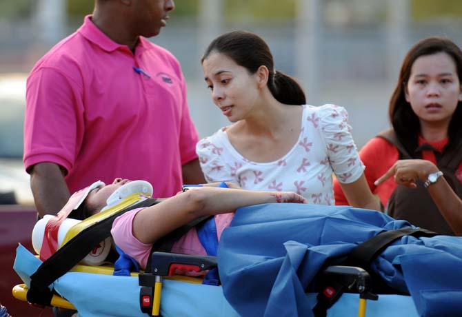 LSU exchange student Parisut Songtip, right, talks to Jinjuta Jirawatjunya, who was hit by a car Wednesday, Oct. 10, at the intersection of Nicholson and North Stadium drives, before heading to the hospital.
 