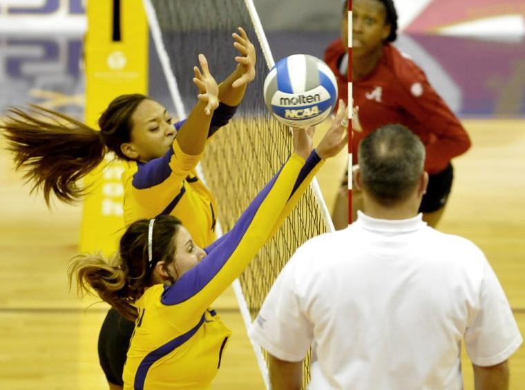 LSU junior middle blocker Desiree Elliott (4) and sophomore setter Malorie Pardo (14) block Sunday, Oct. 14, 2012 during the Tigers' match against Alabama in the PMAC.
 