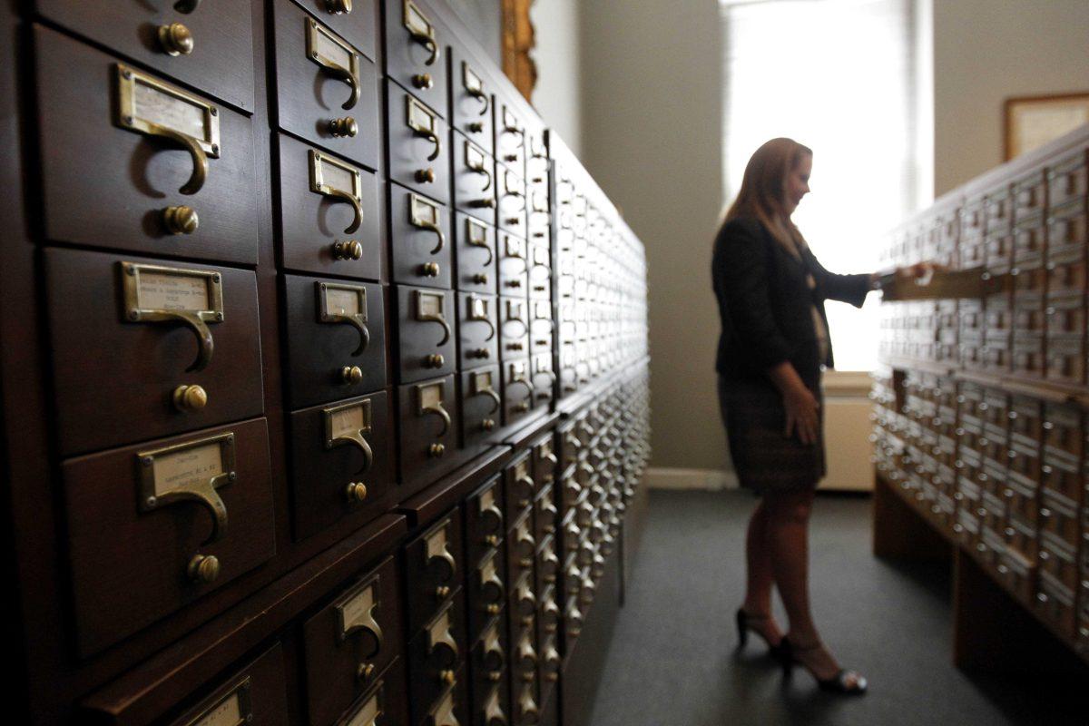 In this Sept. 18, 2012 photo, Sarah-Elizabeth Gundlach, curator, looks through card catalogues of the colonial records index at the Louisiana Historical Center in New Orleans. For years one of America&#8217;s most precious archives: thousands of time-worn 18th-century legal papers written by French and Spanish notaries and court clerks who were among the first in North America to detail the lives of slaves and free blacks, sat in a museum vault in the French Quarter, largely forgotten about and hardly ever read. Slowly, this trove of records now is coming into the modern age. (AP Photo/Gerald Herbert)