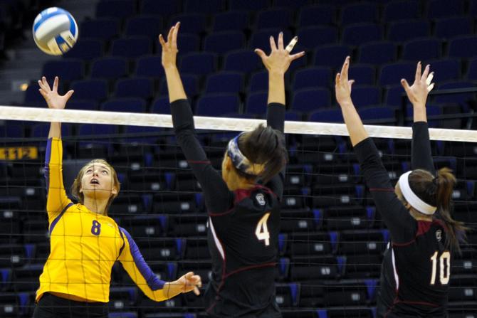 LSU sophomore outside hitter Helen Boyle (8) jumps to hit the ball past South Carolina defenders Sunday, Oct. 7, 2012, during the Tigers' victory against the Gamecocks in the PMAC.
 