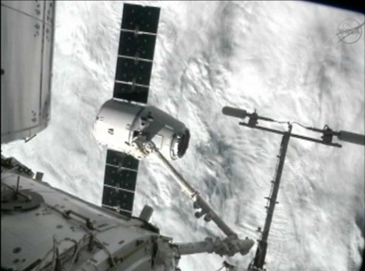 This image from NASA-TV shows the capture of the Dragon capsule by a robot arm on the International Space Station as they passed over the South Atlantic Ocean early Wednesday Oct. 10, 2012. It's the first official delivery by the California-based SpaceX company under a $1.6 billion contract with NASA. The contract calls for 12 such shipments. (AP Photo/NASA)