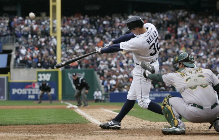 Detroit Tigers' Don Kelly hits a sacrifice fly to right to score teammate Omar Infante during the ninth inning of Game 2 of the American League division baseball series against the Oakland Athletics, Sunday, Oct. 7, 2012, in Detroit. (AP Photo/Duane Burleson)
 