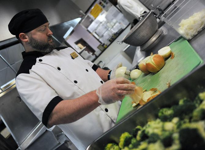 LSU resdient dining executive chef Michael Foster peels onions on Thursday, Oct. 25, 2012 for The 5 dining hall.
 