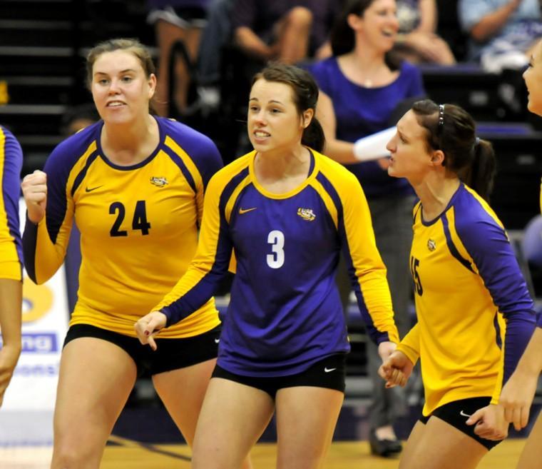 Freshman defensive specialist Haley Smith (15) celebrates with Sam Delahoussaye (3), senior defensive specialist, Friday, Sept. 21, during the Tigers&#8217; win against Kentucky.
 