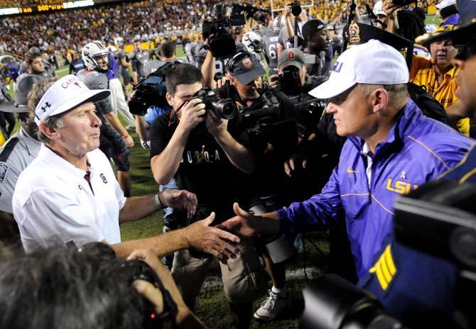 South Carolina head coach Steve Spurrier and LSU head coach Les Miles shake hands Saturday, Oct. 13, 2012 after the Tigers' 23-21 win against South Carolina in Tiger Stadium.
 