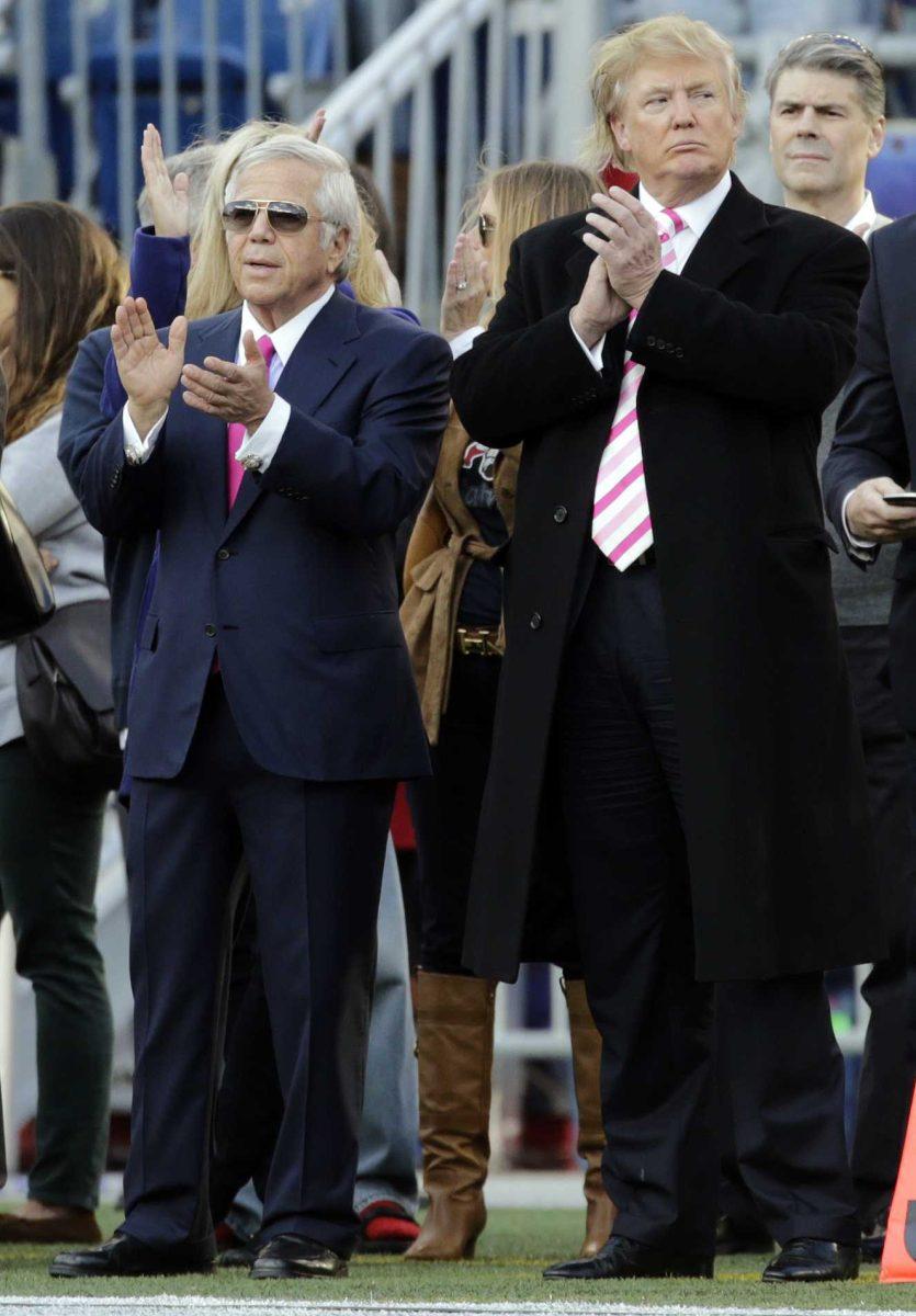 New England Patriots owner Robert Kraft, left, and businessman Donald Trump, right, applaud on the field before an NFL football game between the Patriots and the New York Jets in Foxborough, Mass., Sunday, Oct. 21, 2012. (AP Photo/Charles Krupa)