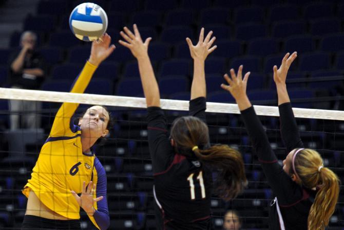 LSU senior outside hitter Madie Jones (6) hits the ball past South Carolina defenders Sunday, Oct. 7, 2012, during the Tigers' victory against South Carolina in the PMAC.
 