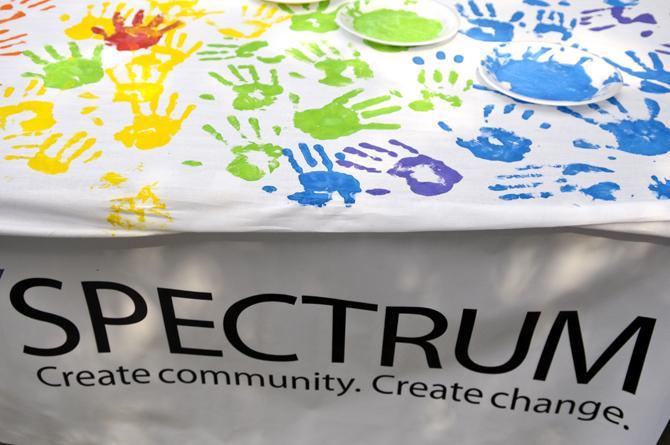 Rainbow colored handprints cover a banner at Spectrum's table Wednesday, Oct. 10, 2012, in Free Speech Alley. Spectrum, a student organization for LGBTQ students and their allies, is celebrating National Coming Out Day.
 