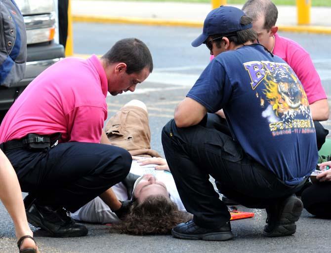 Paramedics examine Andrew Rauch after he was hit by a car while riding his skateboard Wednesday, Oct. 17, 2012.
 