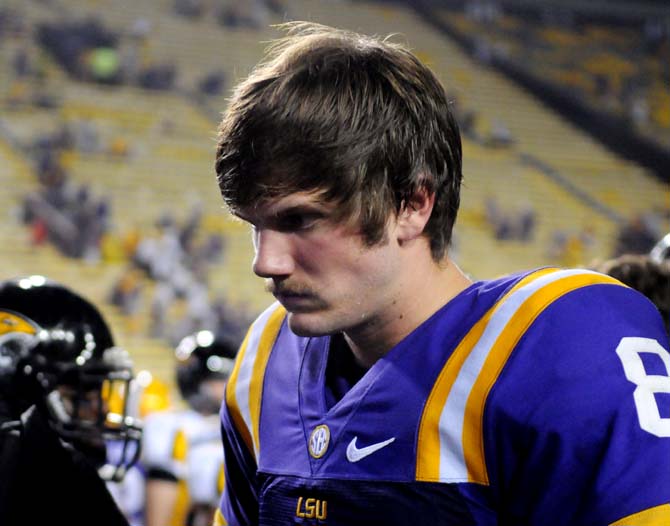 Junior quarterback Zach Mettenberger speaks with the press after the game Saturday while donning a mustache.
 