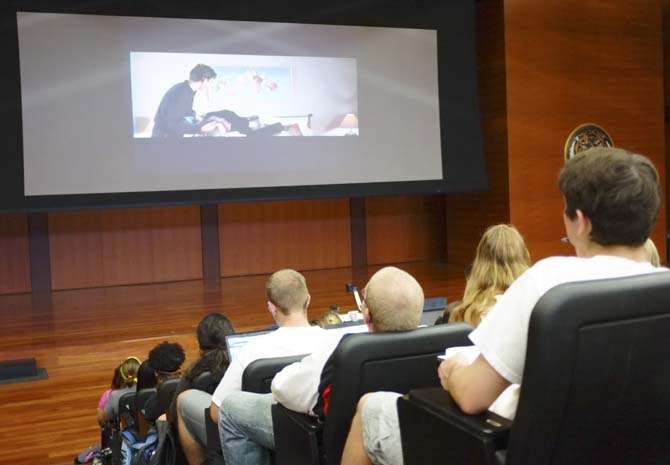 Students in Dottie Vaughns business calculus class watch a clip of the movie "French Kiss" Tuesday afternoon in the Cox Auditorium to illustrate the limits of anxiety that the students might be facing before their first computer based test.
 