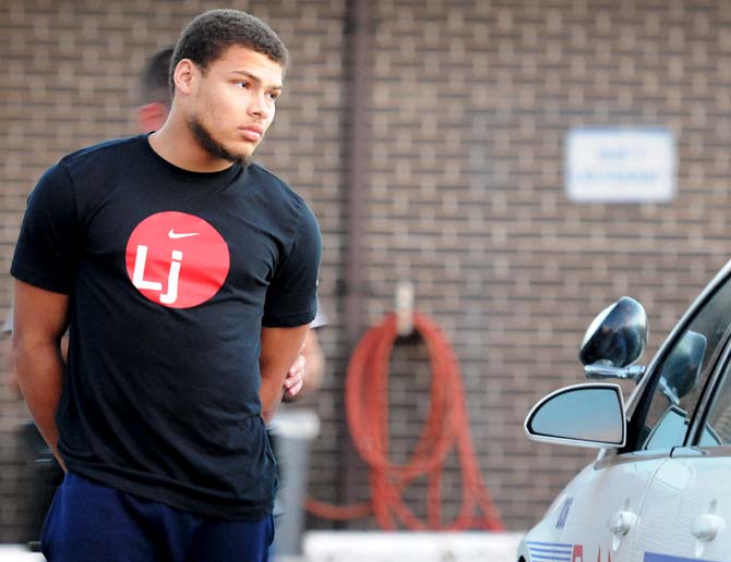 Former LSU star cornerback Tyrann Mathieu is placed in a police car at Baton Rouge Police Department Second District Police Station bound for East Baton Rouge Parish Prison after he and former LSU football players Jordan Jefferson, Derrick Bryant and Karnell Hatcher were found in The Venue at Northgate with 18 grams of marijuana in Baton Rouge, Thursday, Oct. 25, 2012 (AP Photo/The Daily Reveille, Catherine Threlkeld)
 