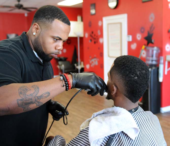 Local barber cuts, paints elaborate designs in hair