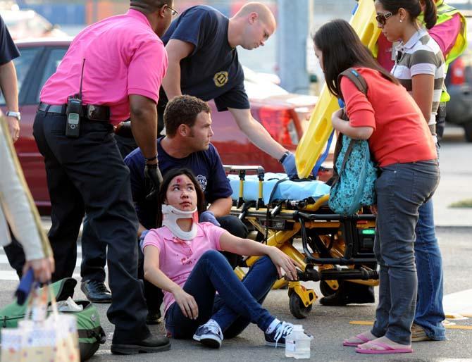 A Baton Rouge fire department paramedic assists Jinjuta Jirawatjunya, international student from Thailand and food science master's student, after she was struck by a car on the corner of Nicholson and North Stadium drives Wednesday, Oct. 10, 2012.
 