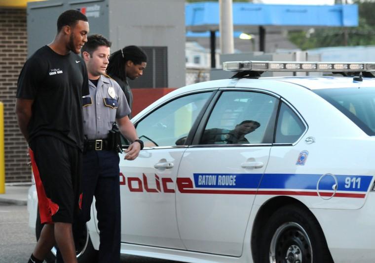 Former LSU quarterback Jordan Jefferson is placed in a police car at Baton Rouge Police Department Second District Police Station bound for East Baton Rouge Parish Prison after he and former LSU football players Tyrann Mathieu, Derrick Bryant and Karnell Hatcher were found in The Venue at Northgate with 18 grams of marijuana in Baton Rouge, Thursday, Oct. 25, 2012 (AP Photo/The Daily Reveille, Catherine Threlkeld)
 