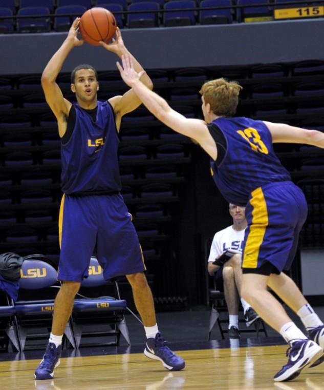 LSU freshman forward Shane Hammink (11), left, tries to throw the ball past senior forward Eddie Ludwig (13) Friday, Oct. 12, 2012, during the men's basketball team's first practice of the season in the PMAC.
 