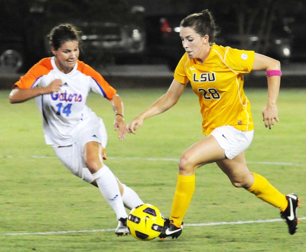 Freshman midfielder Tori Sample, 28, dribbles passed University of Florida senior defender Jo Dragotta, 14, Friday, Oct. 5, 2012 at the LSU Soccer Stadium. The Gators defeated the Tigers 2-0.