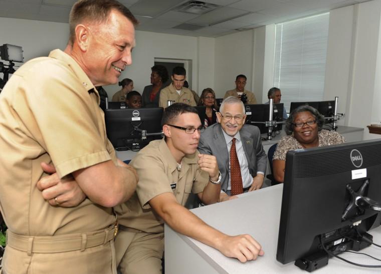 In this photo taken Tuesday, Oct. 9, 2012, Capt. Alton Ross, left, commanding officer of the Southern University Naval ROTC program, watches as Midshipman Morgan Brenton, second from left, works a problem on Southern's Naval ROTC's new Mariner Skills Simulator at the Ronald E. McNair building at Southern University. Observing the process are Southern Chancellor Dr. James Llorens, second from right and Beatrice Armstrong, Executive Assistant to the Provost for Academic Affairs, right. (AP Photo/The Advocate, Patrick Dennis)
 