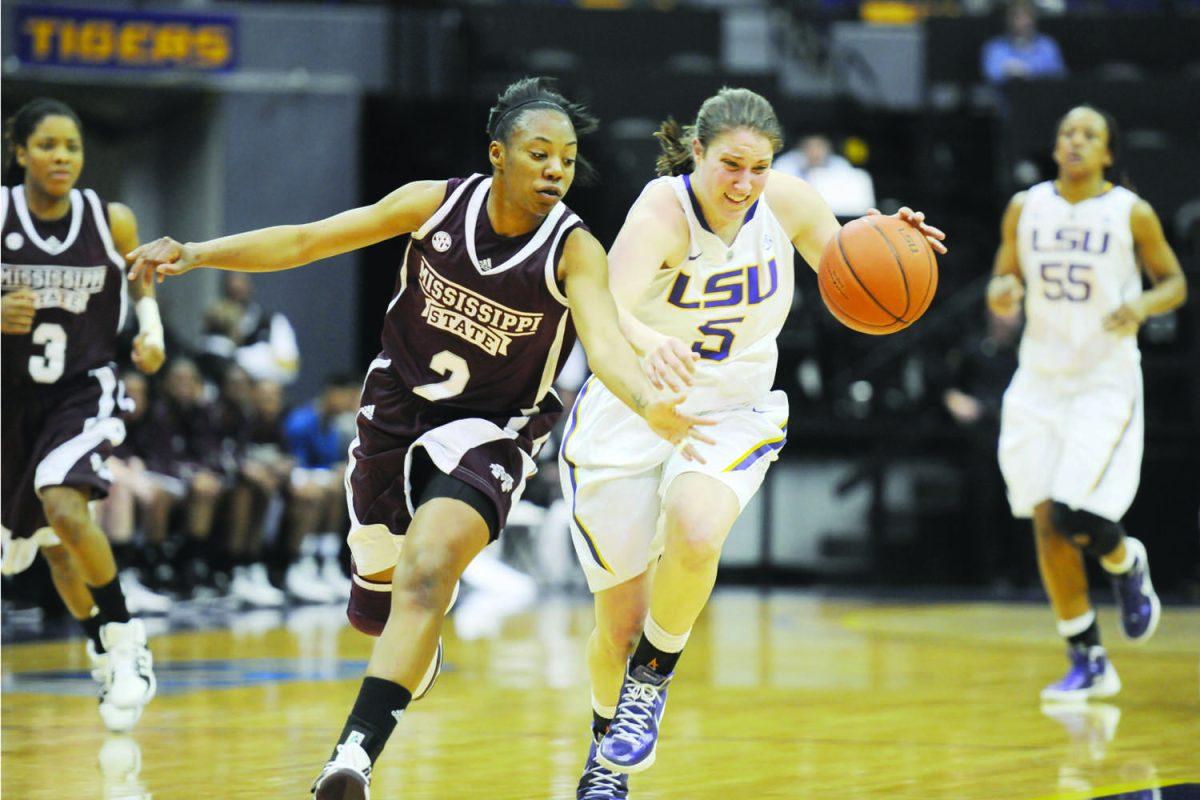 Sophomore guard Jeanne Kenney (5) drives past a Mississippi State defender during the women's basketball game Thursday. LSU defeated MSU 53-49, marking the Lady Tigers' 400th win in the PMAC.