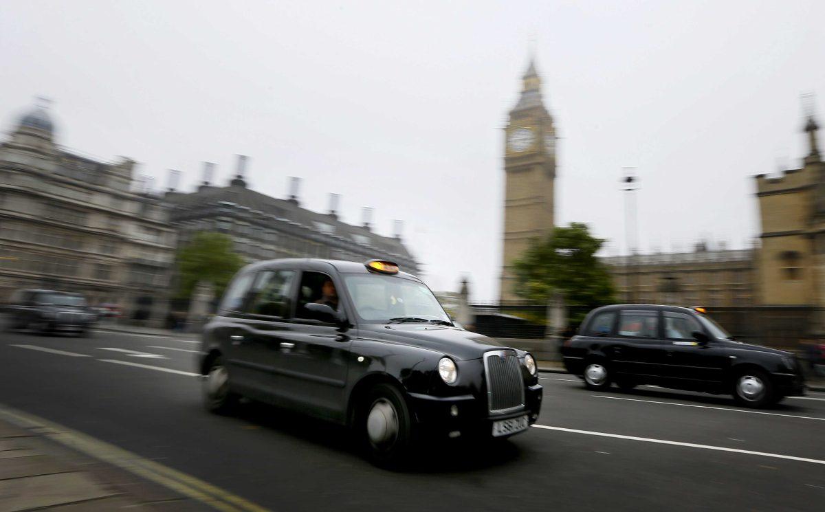 London cabs drive along Parliament Square, London, Monday, Oct. 22, 2012. The maker of London's world famous black cabs says it will go into administration after failing to secure an injection of cash from one of its largest shareholders. Manganese Bronze ran into trouble after discovering a defect with its new steering systems. The problem forced a recall and a suspension of sales that it predicted would have a "material and detrimental" impact on its cash flow. (AP Photo/Kirsty Wigglesworth)